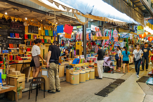 Tourists are shopping at Chatuchak Market in Bangkok, Thailand. Chatuchak Market is the most popular weekend market in Bangkok.