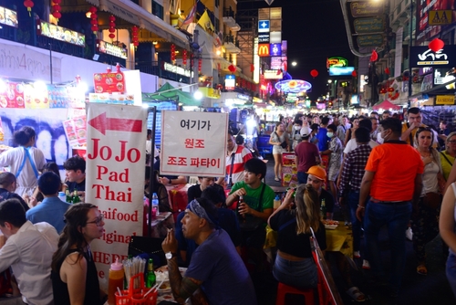 Tourists and backpackers visited at Khao San Road night market. Khao San Road is a famous low budget hotels and guesthouses area in Bangkok, Thailand