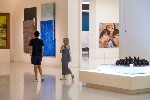 Visitors of the MOCA museum looking at art, Bangkok, Thailand