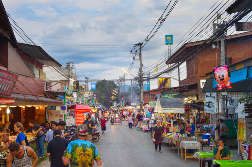 People walking on Pai night market at twilight. Pai is a famous tourist attraction in Mae Hong Son, Thailand