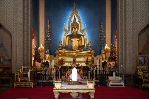 Wat Benchamabophit Dusitwanaram, A serene golden Buddha statue beautifully illuminated in a traditional temple setting during midday, Bangkok, Thailand