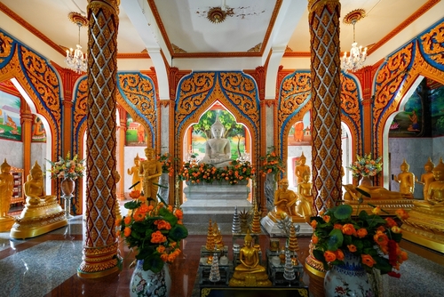 Buddha golden statues in the chedi (pagoda) of the Wat Chalong, a 19th century Buddhist temple on Phuket island in Thailand, Travel with Joy