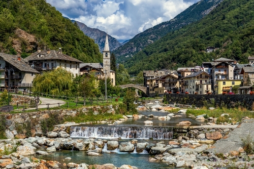 View of alpine river, small town of Fontainemrore and mountains in Aosta Valley, Italy
