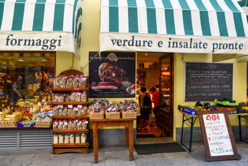 Courmayeur, Aosta Valley, Italy. Exterior of a grocery shop with stands on the sidewalk with fresh local products in the centre of the mountain town