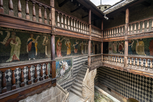 Inner courtyard of of Fenis Castle with medieval frescoes decorating the walls. Fenis, Aosta Valley, Italy