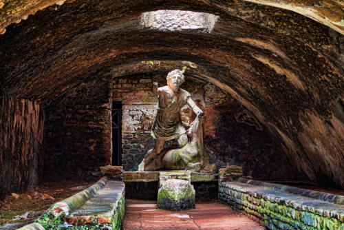 Statue of the god Mithras killing a bull in the thermals mithraeum in the archaeological excavations of Ostia Antica near Rome, Lazio, Italy