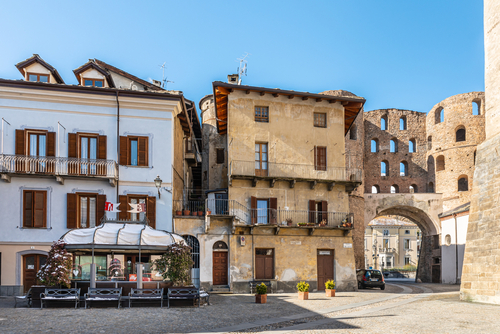 Susa, Piedmont, Italy. View of Piazza San Giusto and the ancient Roman gate called Porta Savoia