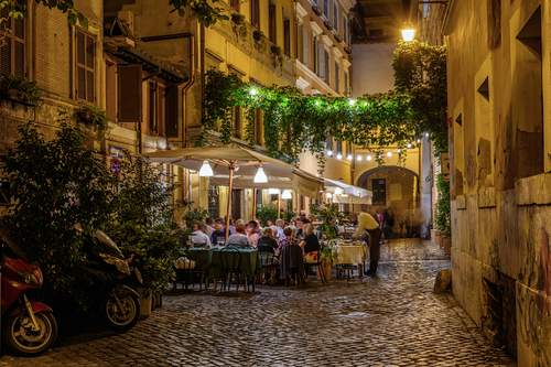 Night view of old cozy street in Trastevere in Rome, Italy. Trastevere is rione of Rome, on the west bank of the Tiber in Rome, Lazio, Italy. Architecture and landmark of Rome
