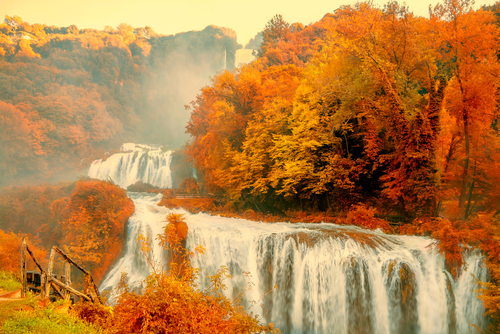 Cascata delle Marmore or Marmore Falls surrounded by Autumn foliage is a man-made waterfall created by the ancient Romans, located near Rome, Lazio, Italy