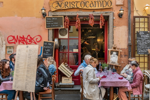 People enjoying a meal at a restaurant in Trastevere district in Rome, Lazio, Italy
