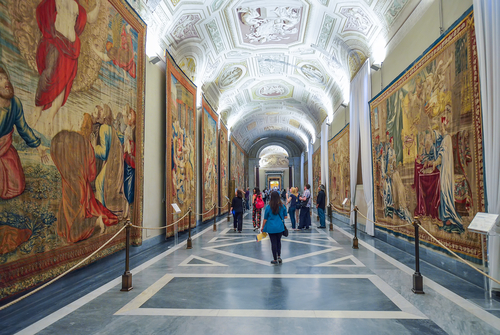 Interior view of the Vatican Museums and people walking through the museum in Rome, Lazio, Italy