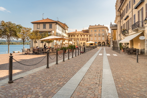 View of Central square with traditional bars, restaurants and shops in center of Arona, located on the shore of Lake Maggiore in Lombardy, Italy