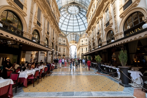 View of people and restaurants at the Galleria Vittorio Emanuele II in Milan, Italy