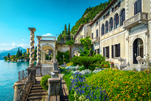 Touristic villa Monastero and amazing ornamental garden with colorful flowers in Varenna resort, lake Como, Lombardy region, Italy