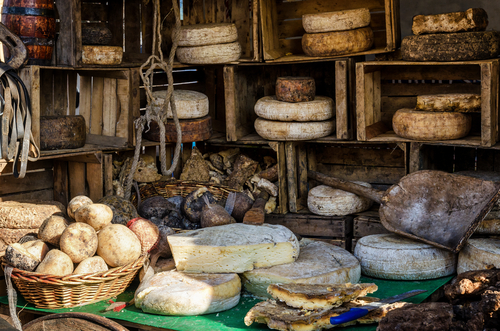 Hard cheese on a street market stall in Turin, Piedmont, Italy