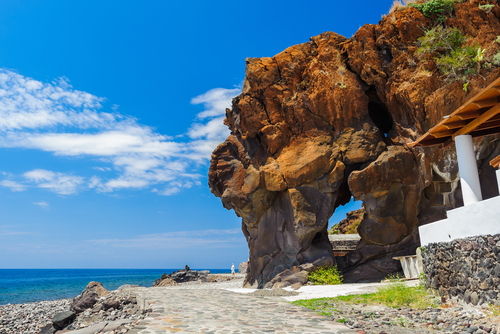 A view of a huge volcanic rock overlooking the sea on the island of Alicudi, Aeolian Islands, near Sicily, Italy