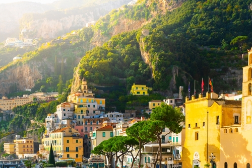 Colorful architecture on the rocks in the town of Amalfi, beautiful cityscape at Sunset on the Amalfi Coast, Mediterranean sea, Campania, Italy