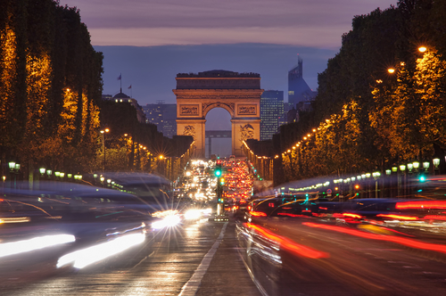 Champs-Elysees boulevard and Arc de Triomphe at night in Paris, France. Night cityscape of Paris