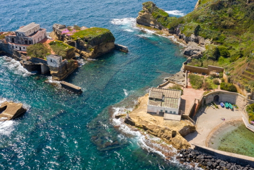 Aerial view of the Gaiola beach and island located in the Posillipo district, in Naples, Campania, Italy. The area is part of Underwater Park of Gaiola, a protected marine reserve and overlooks Tyrrhenian Sea