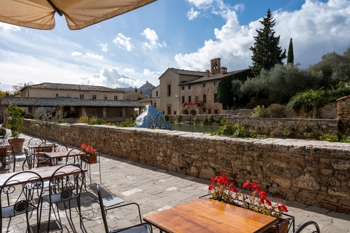 Ancient natural hot springs stone pool in small Italian village Bagno Vignoni in Val d'Orcia, Tuscany, Italy