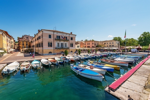 Small old port of the city of Bardolino with many boats moored. Tourist resort on the coast of Lake Garda (Lago di Garda), Veneto, Italy
