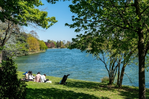 Parisians relaxing on the lower lake in the Bois de Boulogne on a sunny weekend of April in Paris, France