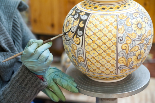 View of a ceramic pot being decorated by a local artisan in Caltagirone, Sicily, Italy