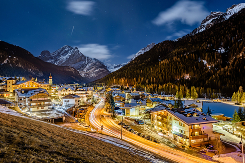 Sunny view of Canazei on the background of Dolomites of Val di Fassa, Trentino-Alto-Adige region, Italy