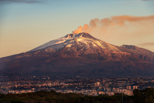 The mount Etna Volcano with smoke and Catania, Sicily, Italy (Sicilia, Italia)