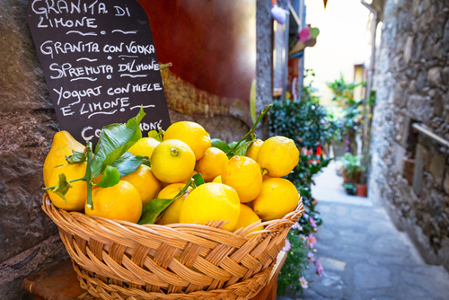 A wicker basket full of fresh lemon in a street at the village of Corniglia, Cinque Terre nation park, Liguria, Italy