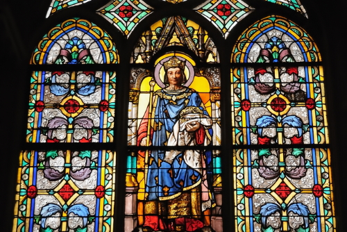 Stained-glass window in Eglise St Germain l'Auxerrois with medieval scenes in Paris, France. Mixed styles church is known from the 7th century and was rebuilt many times