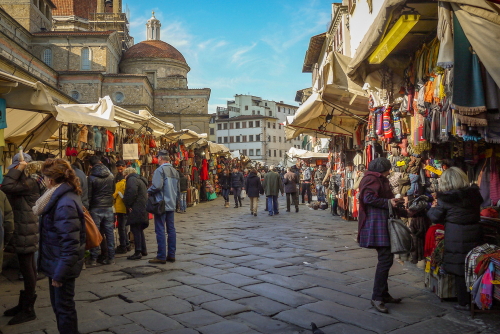 The outdoor area of the San Lorenzo markets full of stalls selling leather, clothing and souvenirs to tourists in Florence, Tuscany, Italy