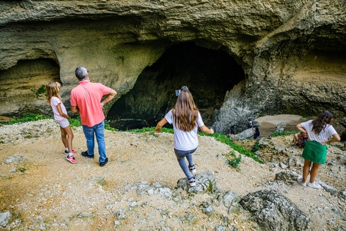 Tourists visiting the spring of Fontaine de Vaucluse, the source of the Sorgue river, with a very low level of water, Provence, France