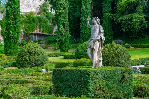 View of a sculpture amongst the luscious greenery of Giardino Giusti garden in Verona, Veneto, Italy