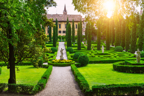 Beautiful view of sculptures amongst the luscious greenery of Giardino Giusti in Verona, Veneto, Italy