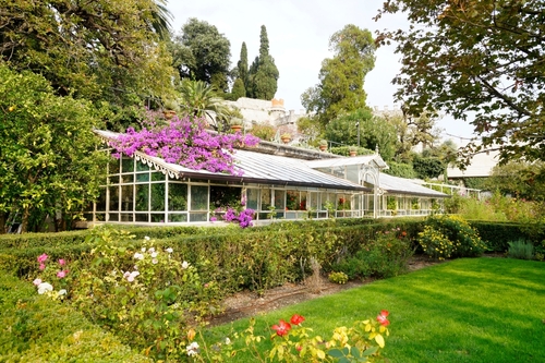 A picturesque view of mediterranean garden with tropical trees on Isola del Garda in La Garda lake, Northern Italy