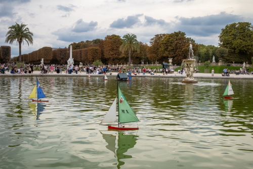 Model sailing boats glide across the pond in the heart of the popular Jardin du Luxembourg in Paris, France