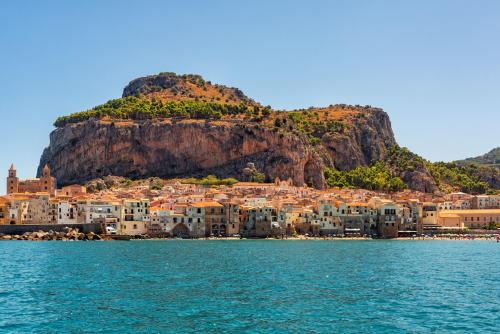 View of Cefalu, Metropolitan City of Palermo, coastal town in northern Sicily, Italy. Old buidings, the Duomo, a Norman Cathedral and La Rocca, a huge rocky mountain
