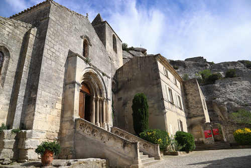 Small Church of Saint Vincent, a 12th century architecture artwork partly built into the rocks behind it in Les Baux-de-Provence, Provence, France
