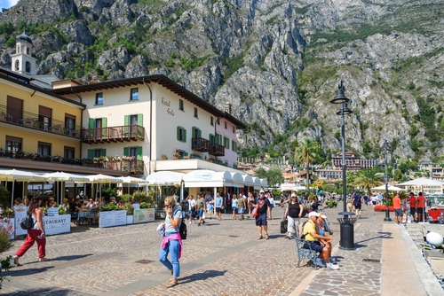 Beautiful main promenade with tourists in famous tourist destination Limone Sul Garda, La Garda lake, Lombardy, Italy