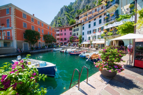 Beautiful view of the small harbour with flowers in Limone Sul Garda, La Garda lake, Lombardy, Italy