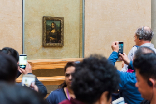 View of the famous Mona Lisa painting at the Louvre Museum in Paris, France