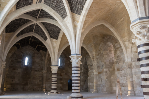 View of a large room inside the castle of Maniace, perspective of historical vaults and columns in Ortygia island, Syracuse, Sicily, Italy