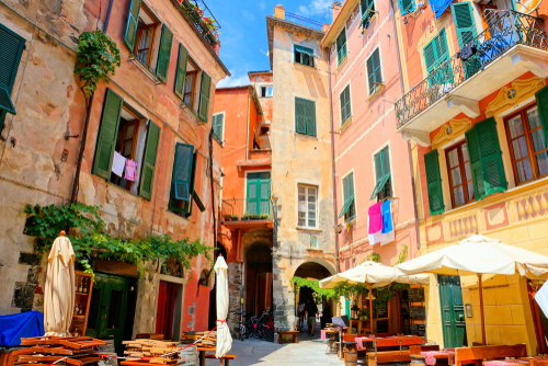 Colorful square and houses with restaurant tables in the village of Monterosso al Mare, Cinque Terre National Park, Liguria, Italy