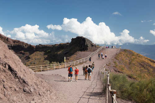 Tourists on the path leading along the crater of the Mount Vesuvius, famous Italian volcano near Naples, Campania, Italy