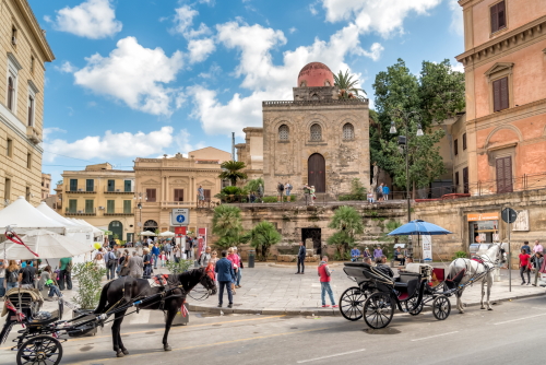 Tourists visiting Bellini square with Saint Cataldo church in the center of Palermo, Sicily, Italy