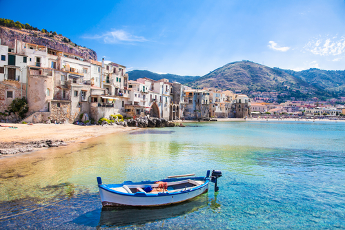 Beautiful old harbor with wooden fishing boat in Cefalu, Sicily, Italy