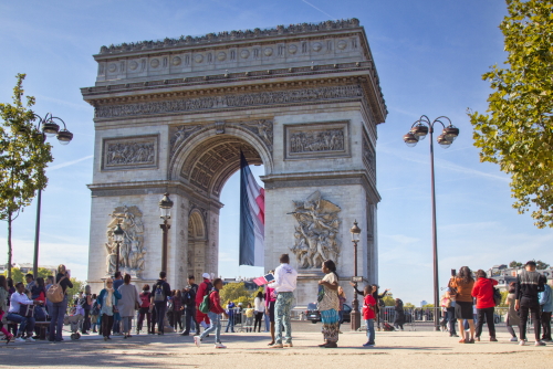 People visiting the magnificent Arc de Triomphe in Paris, France