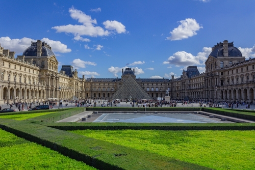 A scenic view of the Louvre Museum at the heart of Paris, France in daylight