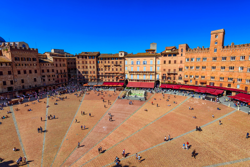 Many people walking through Piazza del Campo in Siena, Tuscany, Italy